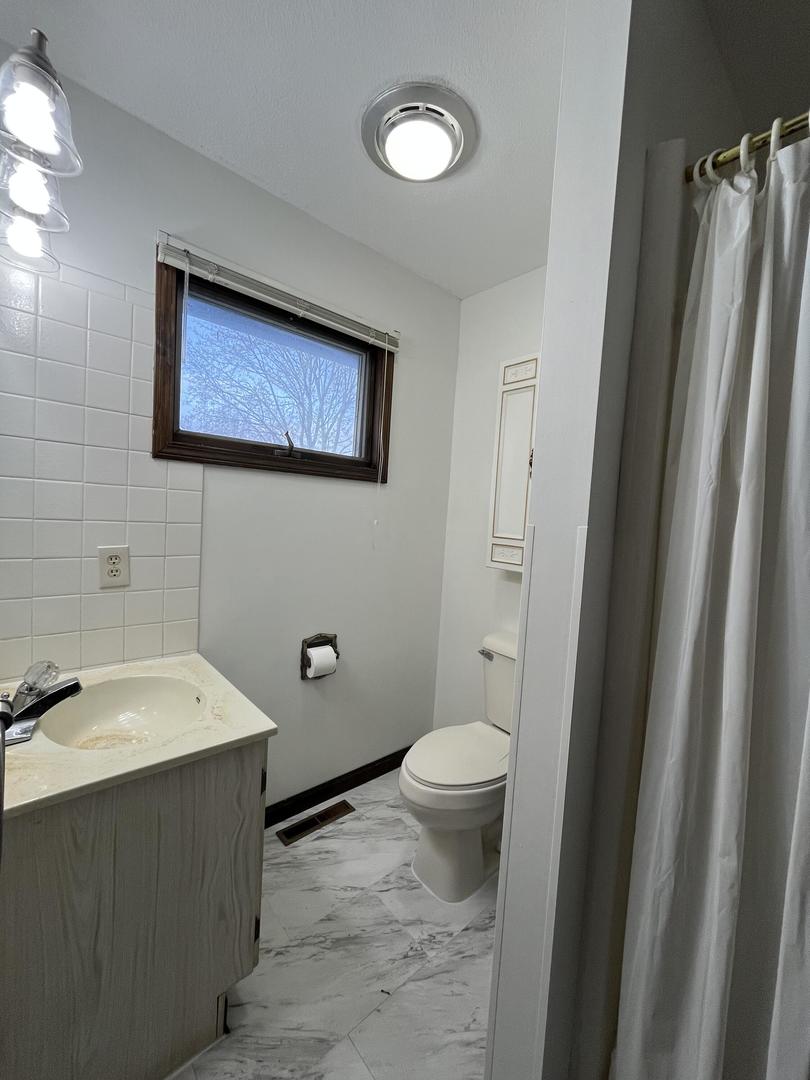 57 Jibby Estates Sullivan, IL 61951 - Photo 14 of 16 a bathroom with a sink and a mirror