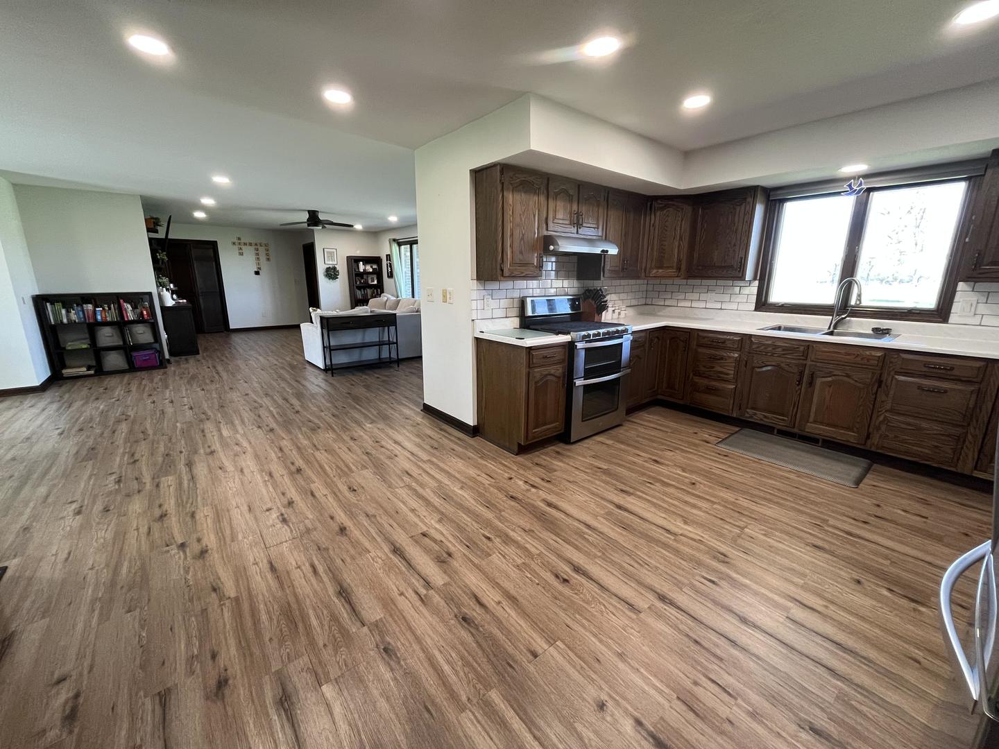 57 Jibby Estates Sullivan, IL 61951 - Photo 3 of 16 a large kitchen with wooden floors and stainless steel appliances