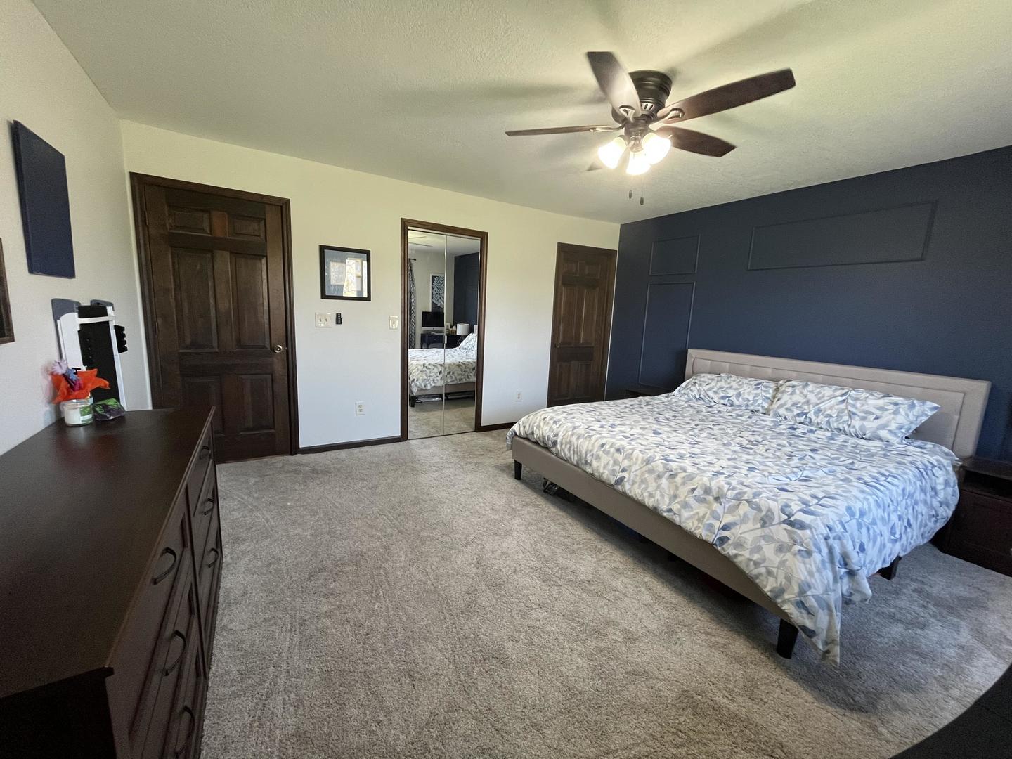 57 Jibby Estates Sullivan, IL 61951 - Photo 7 of 16 a bedroom with a bed and a chandelier