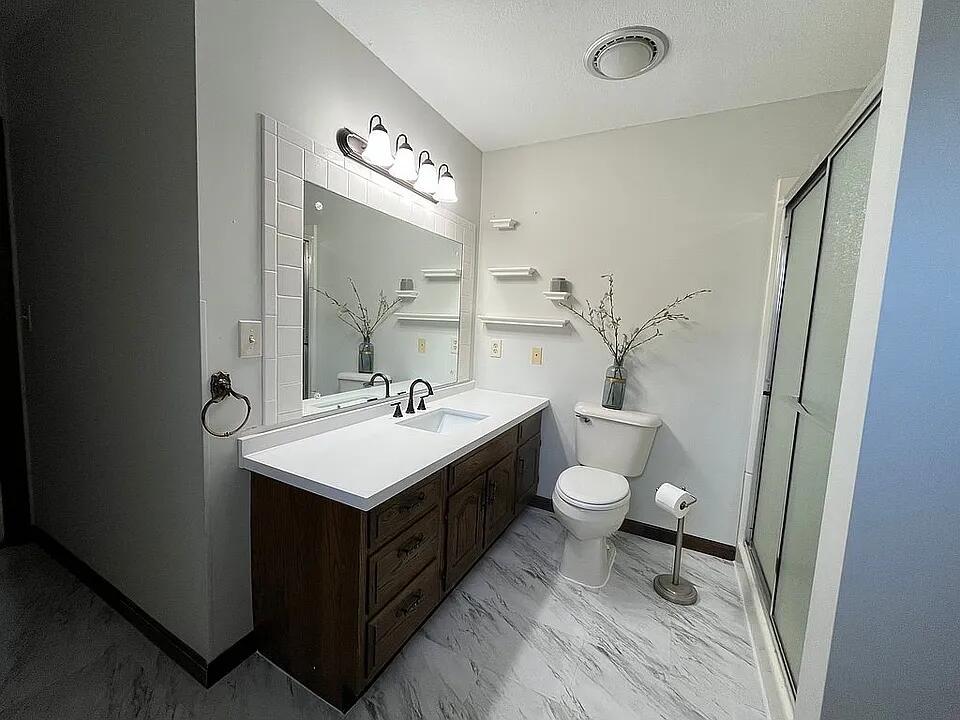 57 Jibby Estates Sullivan, IL 61951 - Photo 9 of 16 a bathroom with a toilet a sink and a mirror