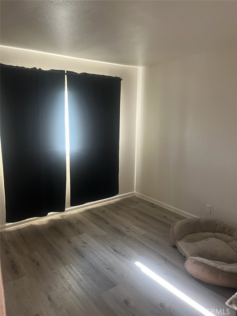 44706 Sarah Lane Lancaster, CA 93535 - Photo 11 of 17 a view of an empty room with wooden floor and a window