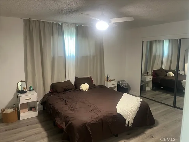 a bedroom with a bed and a large mirror