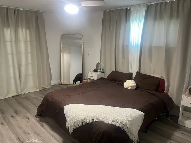 a bedroom with a bed and a mirror