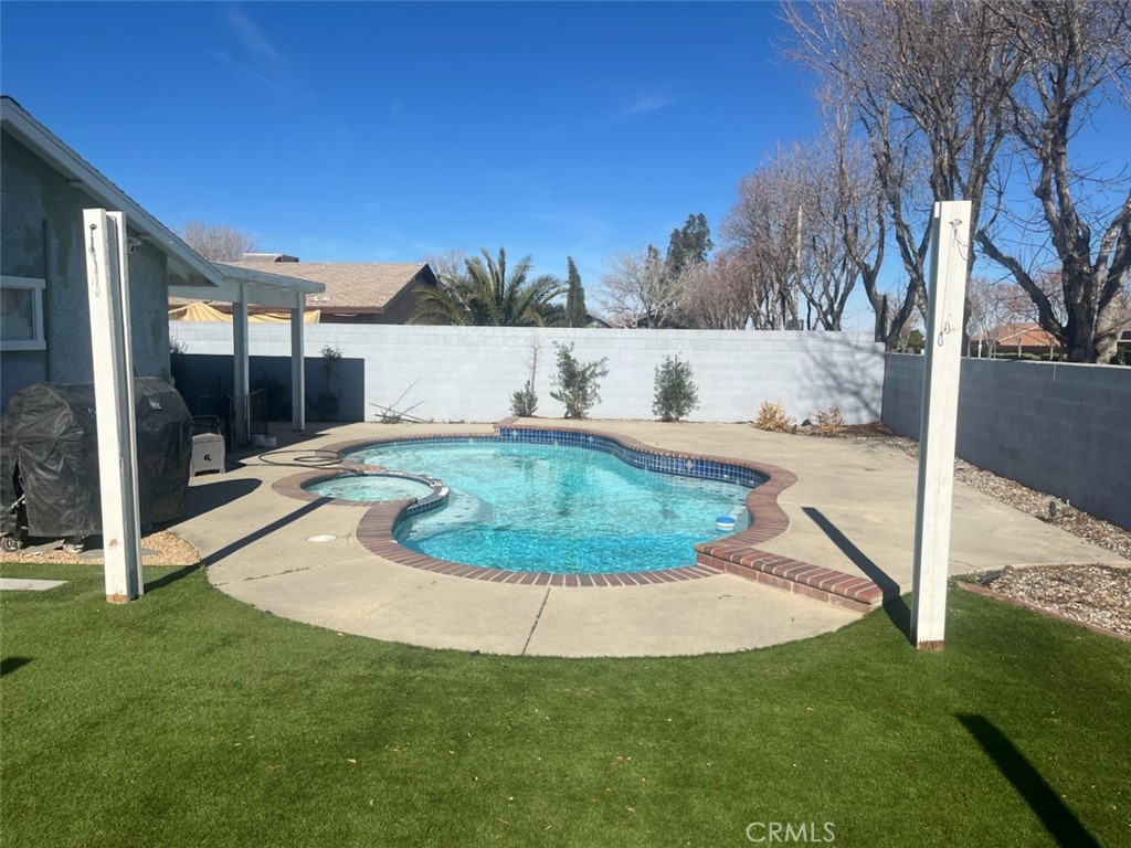 44706 Sarah Lane Lancaster, CA 93535 - Photo 16 of 17 a view of a swimming pool with a yard