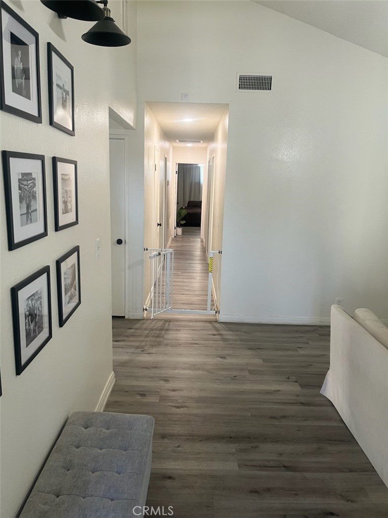 44706 Sarah Lane Lancaster, CA 93535 - Photo 4 of 17 a view of a hallway with wooden floor and chandelier