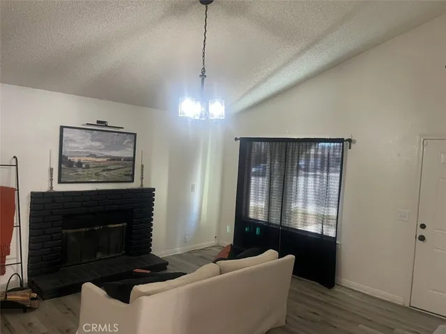 a living room with furniture a window and a fireplace