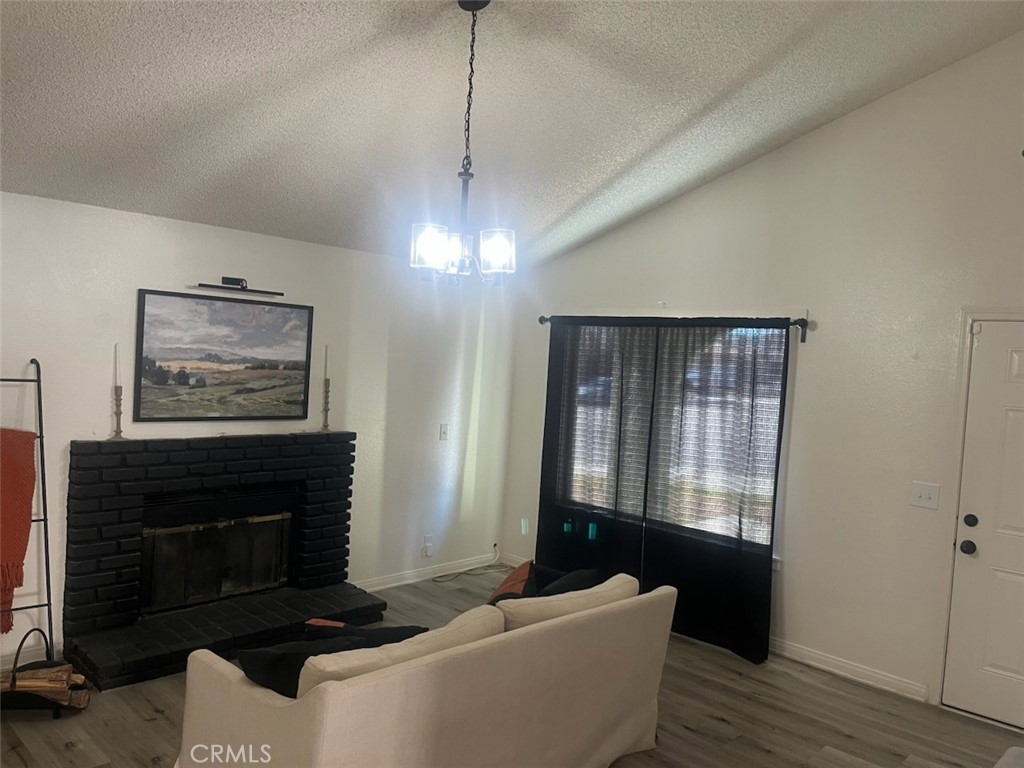 44706 Sarah Lane Lancaster, CA 93535 - Photo 5 of 17 a living room with furniture a window and a fireplace