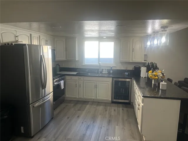 a kitchen with a sink appliances and cabinets