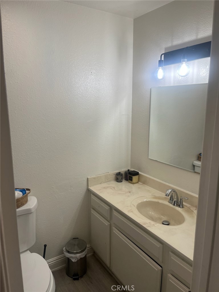 44706 Sarah Lane Lancaster, CA 93535 - Photo 10 of 17 a bathroom with a sink toilet and a mirror