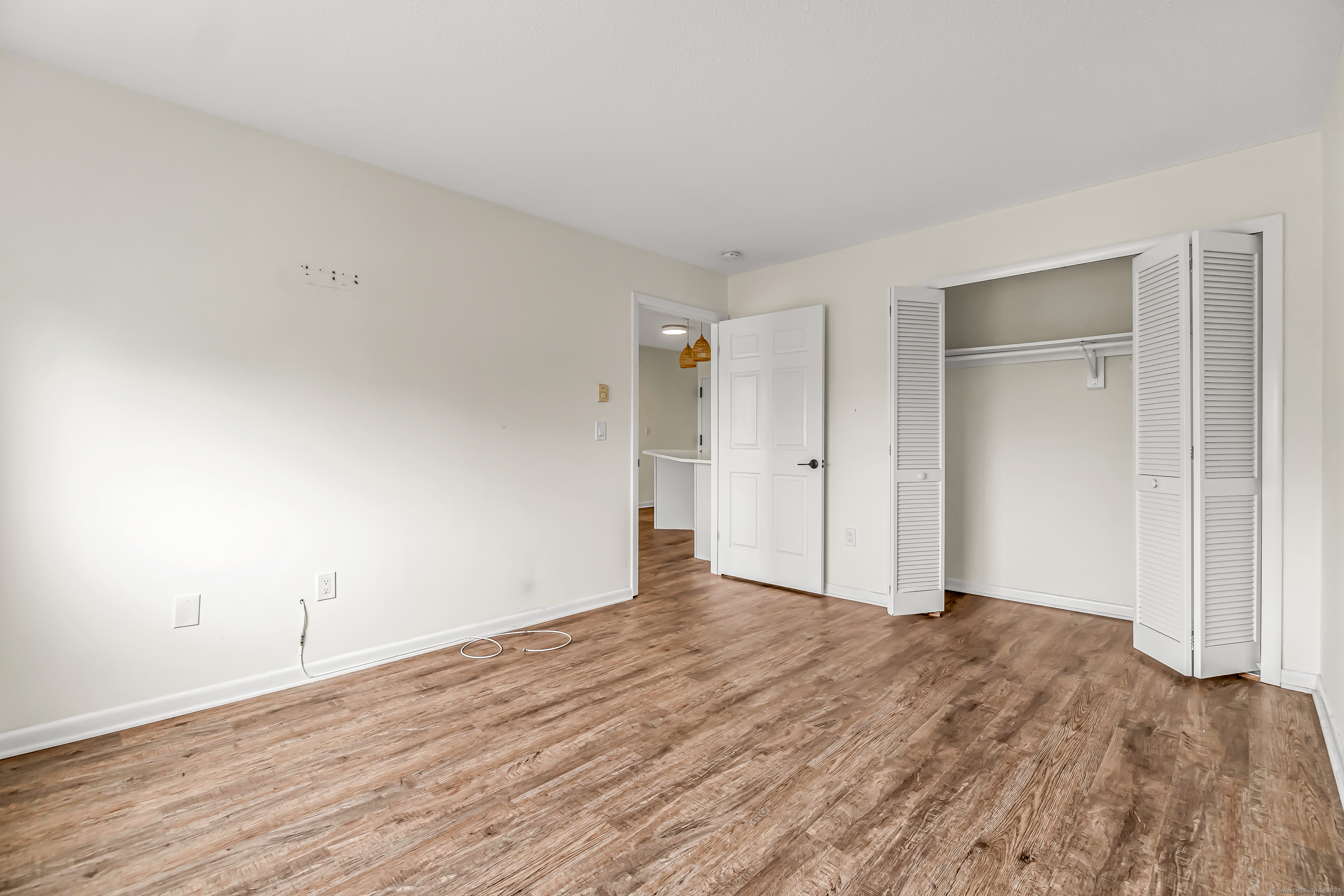 115 Short Beach Road, Unit 104 Stratford, CT 06615 - Photo 12 of 19 a view of an empty room and wooden floor