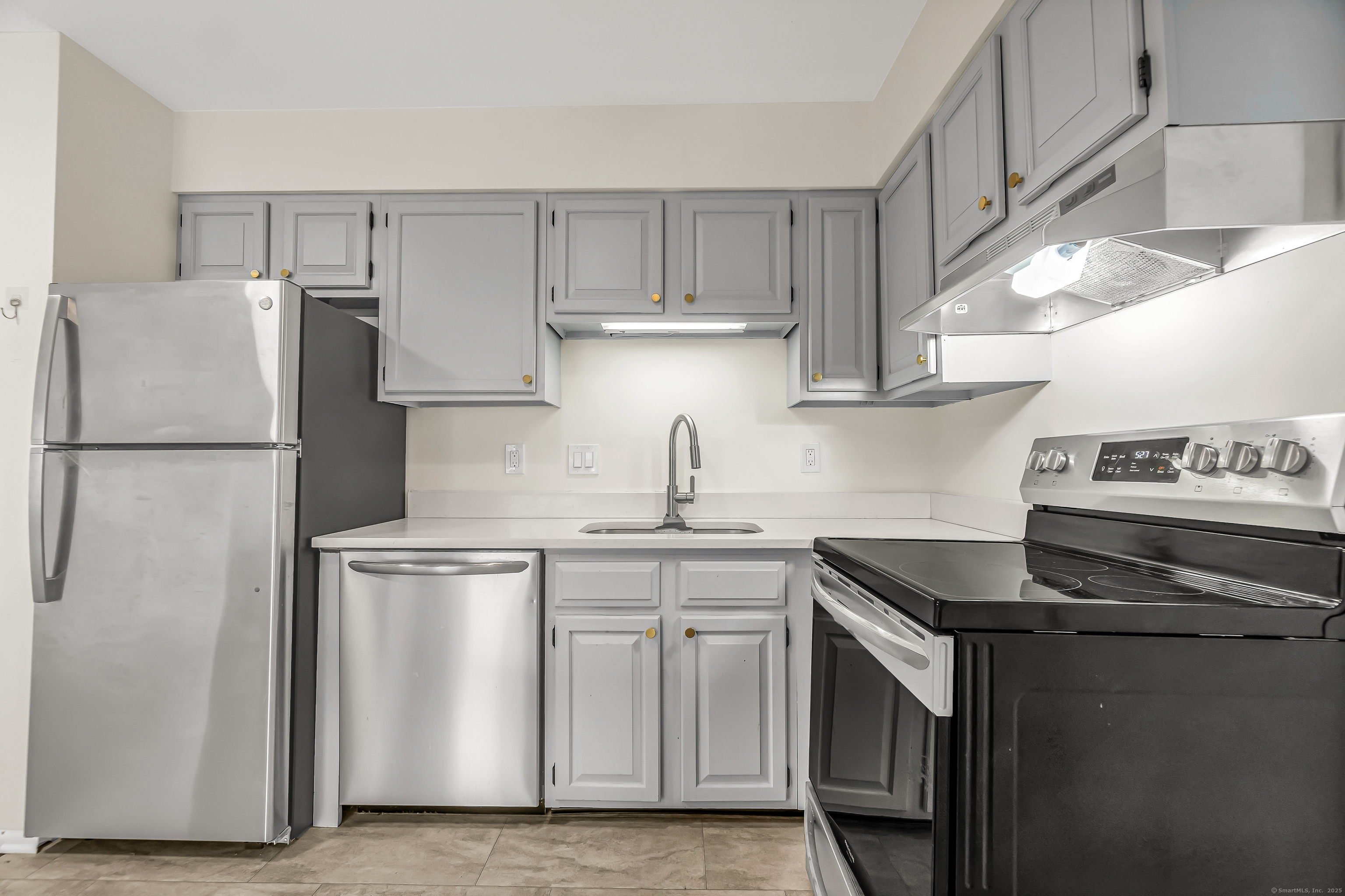 115 Short Beach Road, Unit 104 Stratford, CT 06615 - Photo 7 of 19 a kitchen with stainless steel appliances granite countertop a sink stove and refrigerator