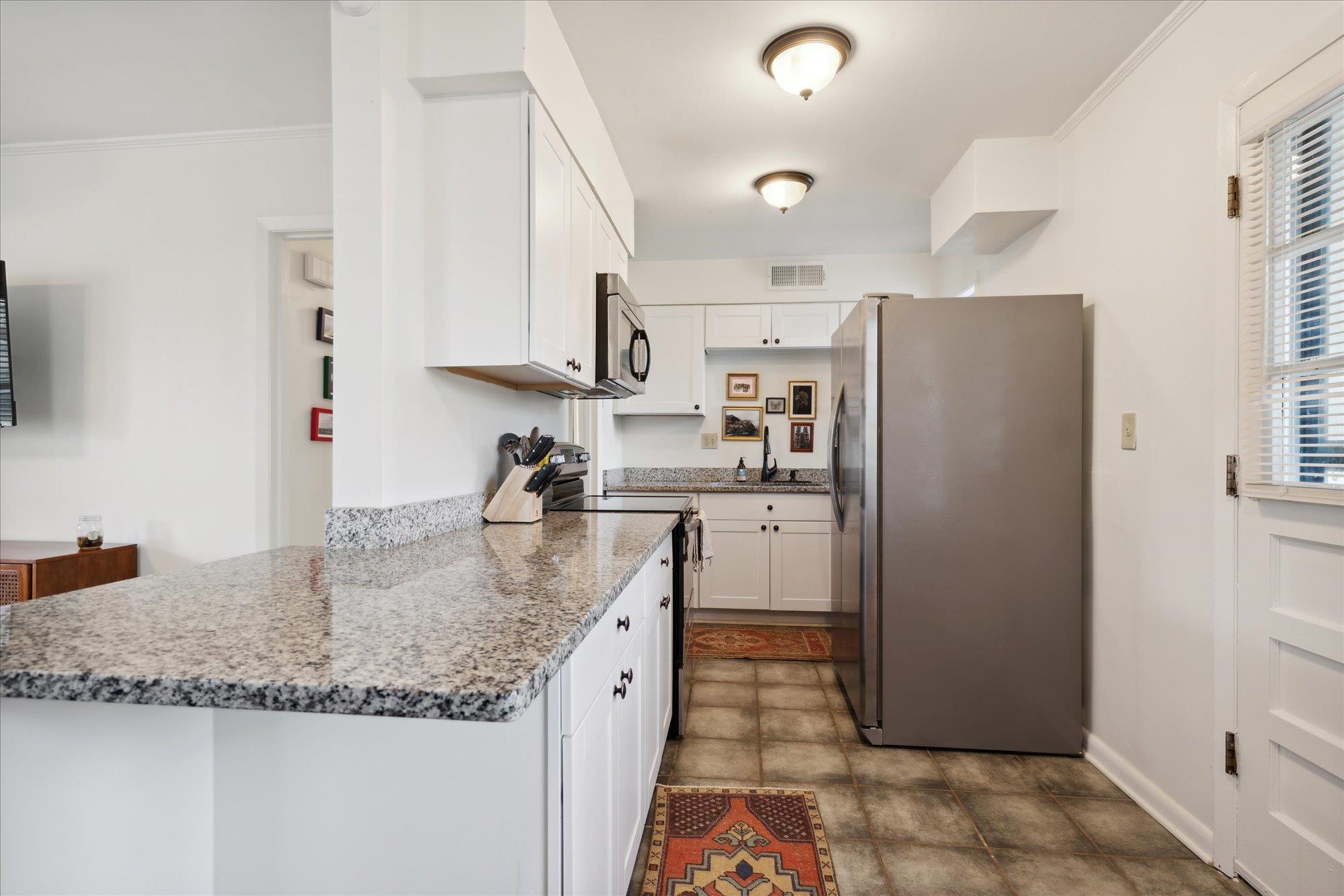 1529 Welsh Road Memphis, TN 38117 - Photo 12 of 27 a kitchen with stainless steel appliances granite countertop a refrigerator and a sink