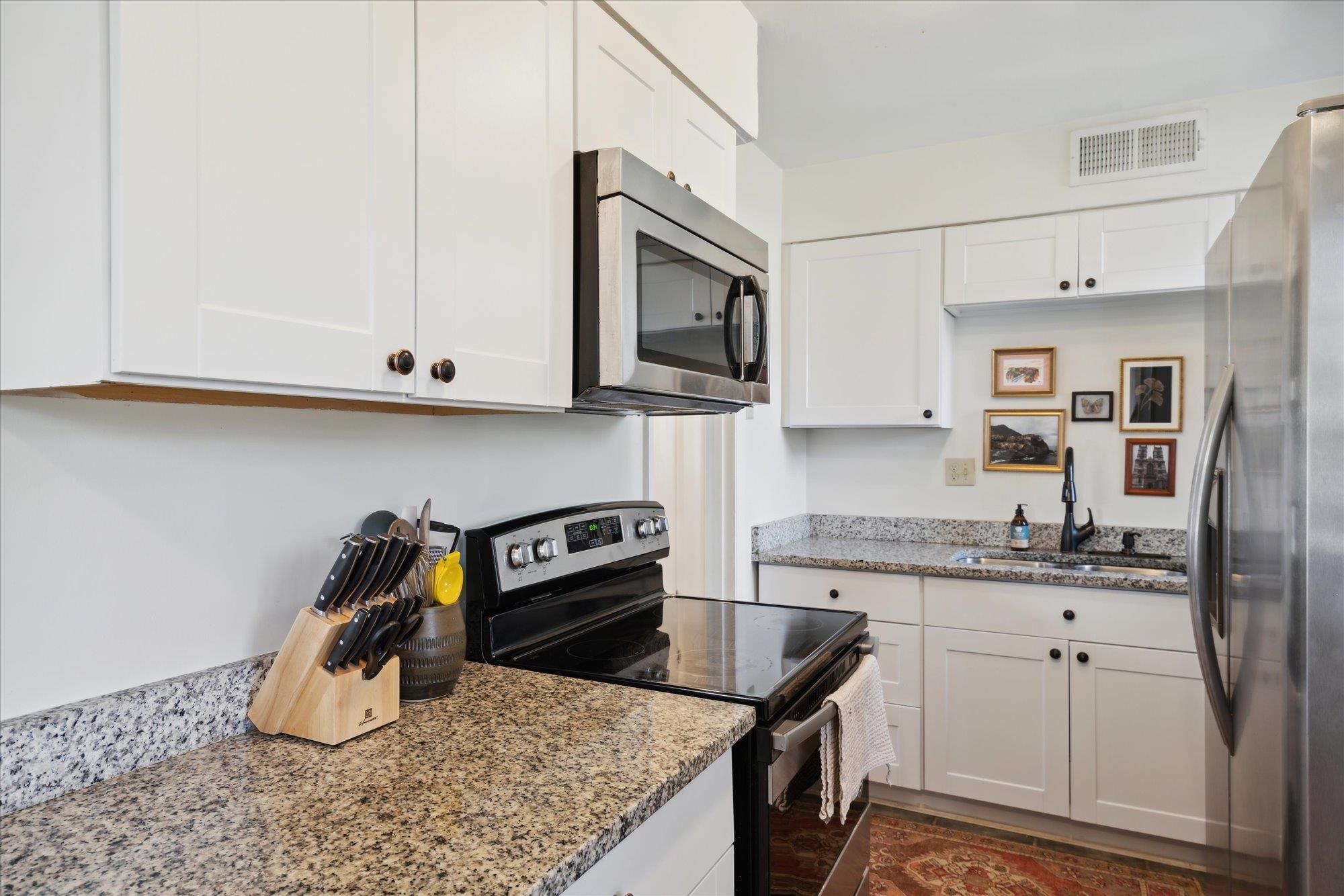 1529 Welsh Road Memphis, TN 38117 - Photo 13 of 27 a kitchen with stainless steel appliances granite countertop a sink stove and cabinets