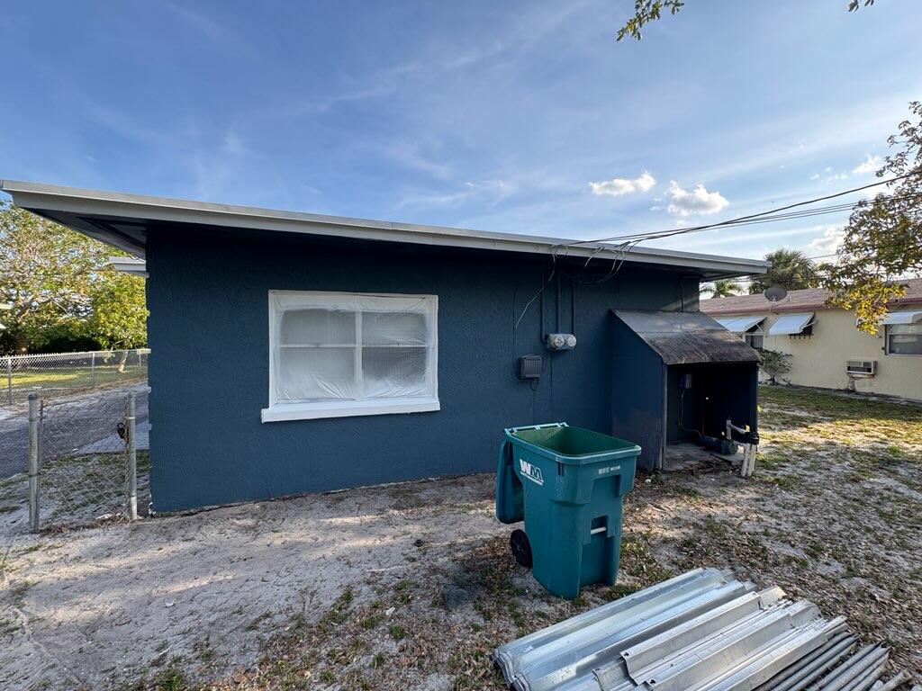 112 West 34th Street, Unit 1 Riviera Beach, FL 33404 - Photo 2 of 23 a room with fireplace and stairs
