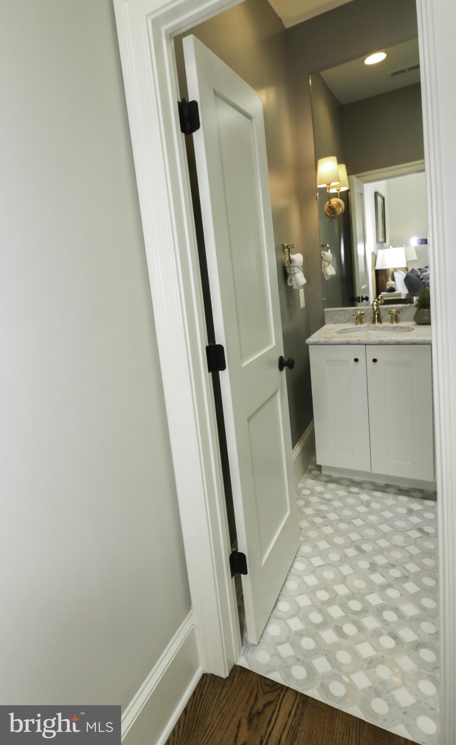 124 11th Street Northeast Washington, DC 20002 - Photo 17 of 30 a bathroom with a sink a toilet a mirror and shower