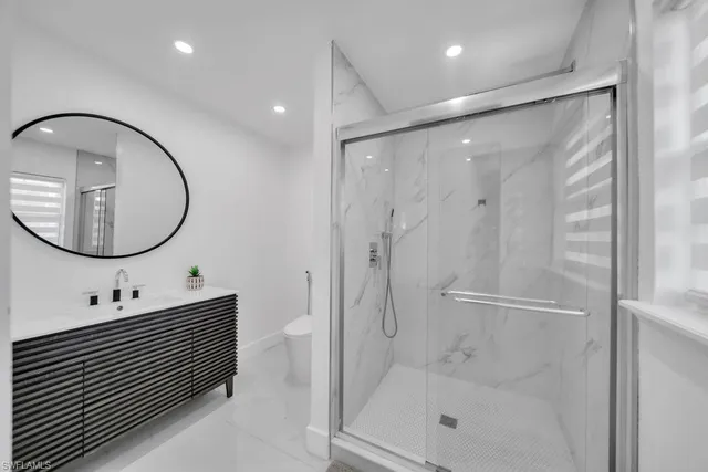 a bathroom with a mirror a double vanity sink and a mirror