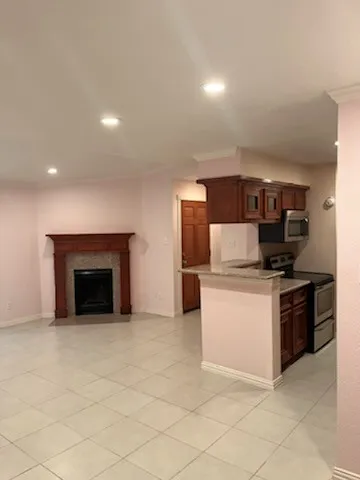 a kitchen with stainless steel appliances granite countertop a stove top oven and sink