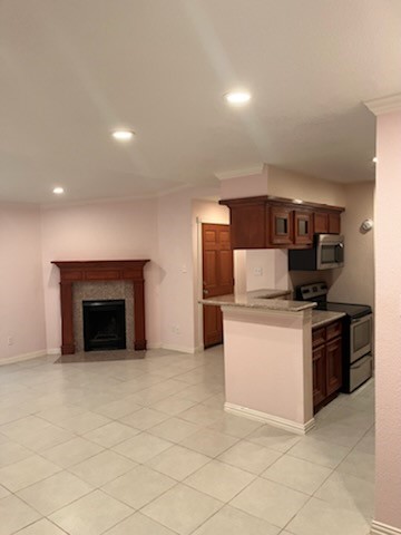a kitchen with stainless steel appliances granite countertop a stove top oven and sink