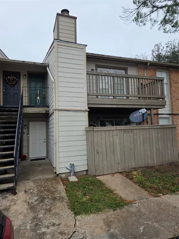 a view of wooden house and a yard