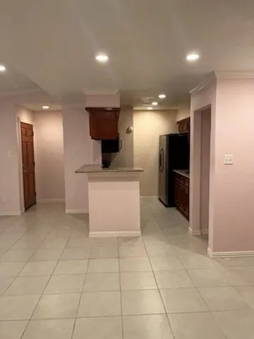 a view of a kitchen with a sink and a refrigerator