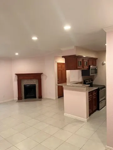 a kitchen with stainless steel appliances granite countertop a stove top oven and sink