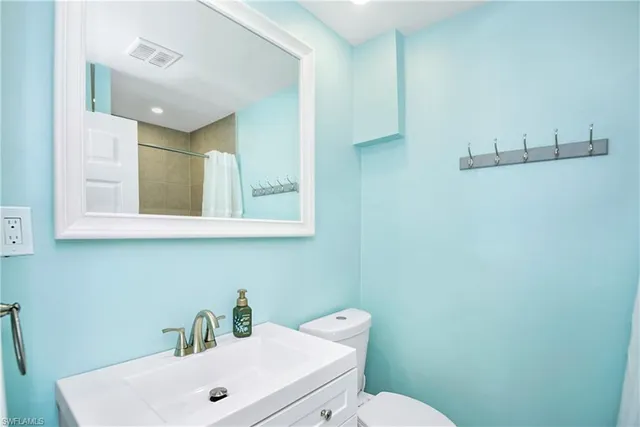 a living room with furniture and a view of bathroom