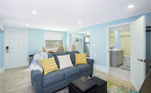 a kitchen with granite countertop a sink stainless steel appliances and white cabinets
