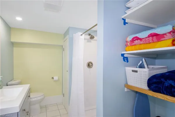 a bathroom with a sink mirror vanity and toilet
