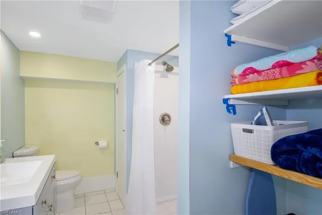 a bathroom with a sink mirror vanity and toilet