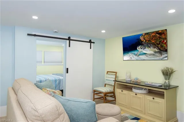 a bedroom with a bed and painting on the wall