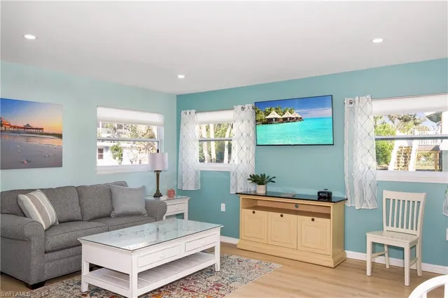 a kitchen with stainless steel appliances white cabinets and a stove a refrigerator a sink