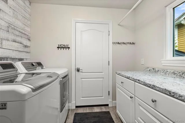 a utility room with cabinets washer and dryer