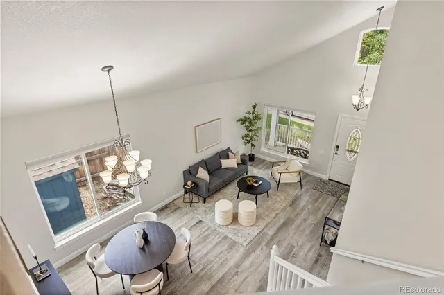 a dining room with furniture and wooden floor