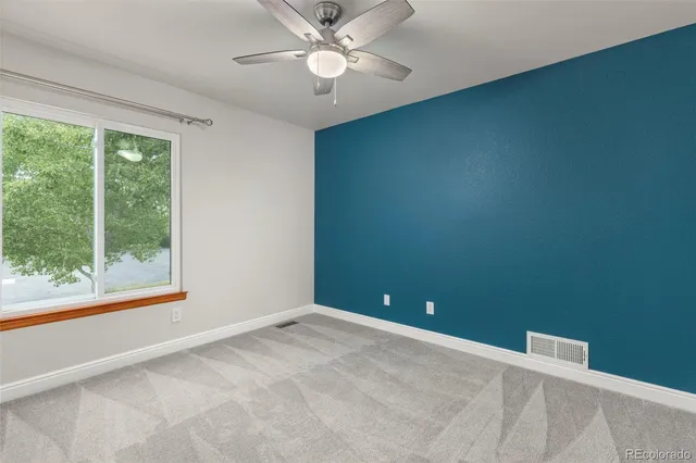 a view of room with window and ceiling fan