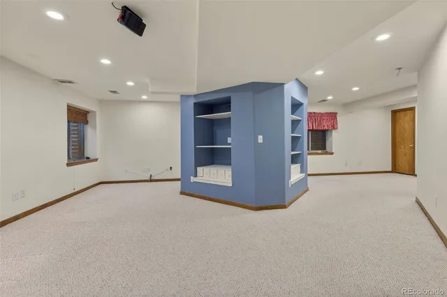 a view of an empty room with a kitchen