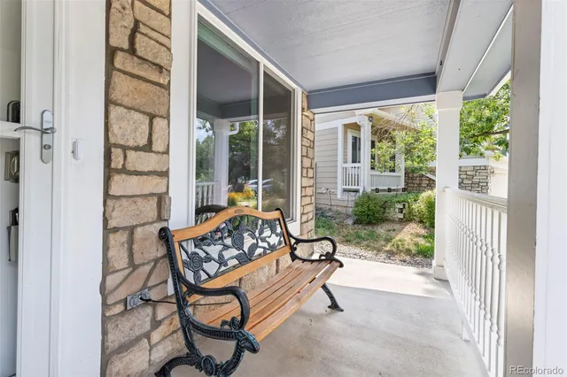 a bedroom with furniture and a large window
