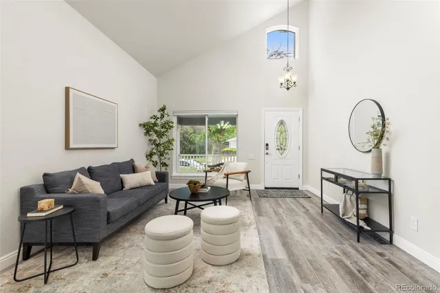 a living room with furniture a clock and a window
