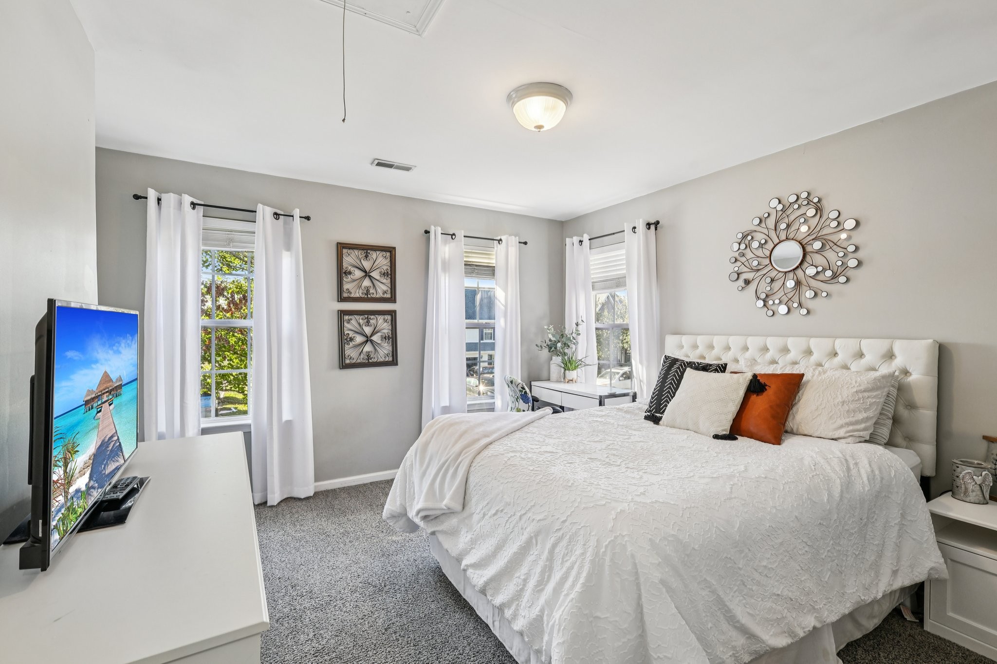 1613 Harrison Way Spring Hill, TN 37174 - Photo 24 of 38 a bedroom with a large bed and a flat tv screen on dresser