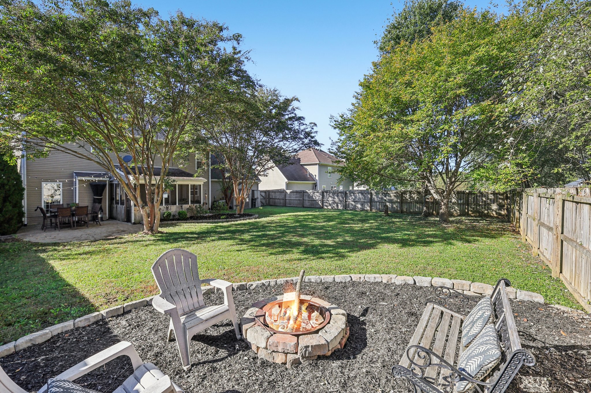 1613 Harrison Way Spring Hill, TN 37174 - Photo 34 of 38 a view of a backyard with table and chairs potted plants and large tree