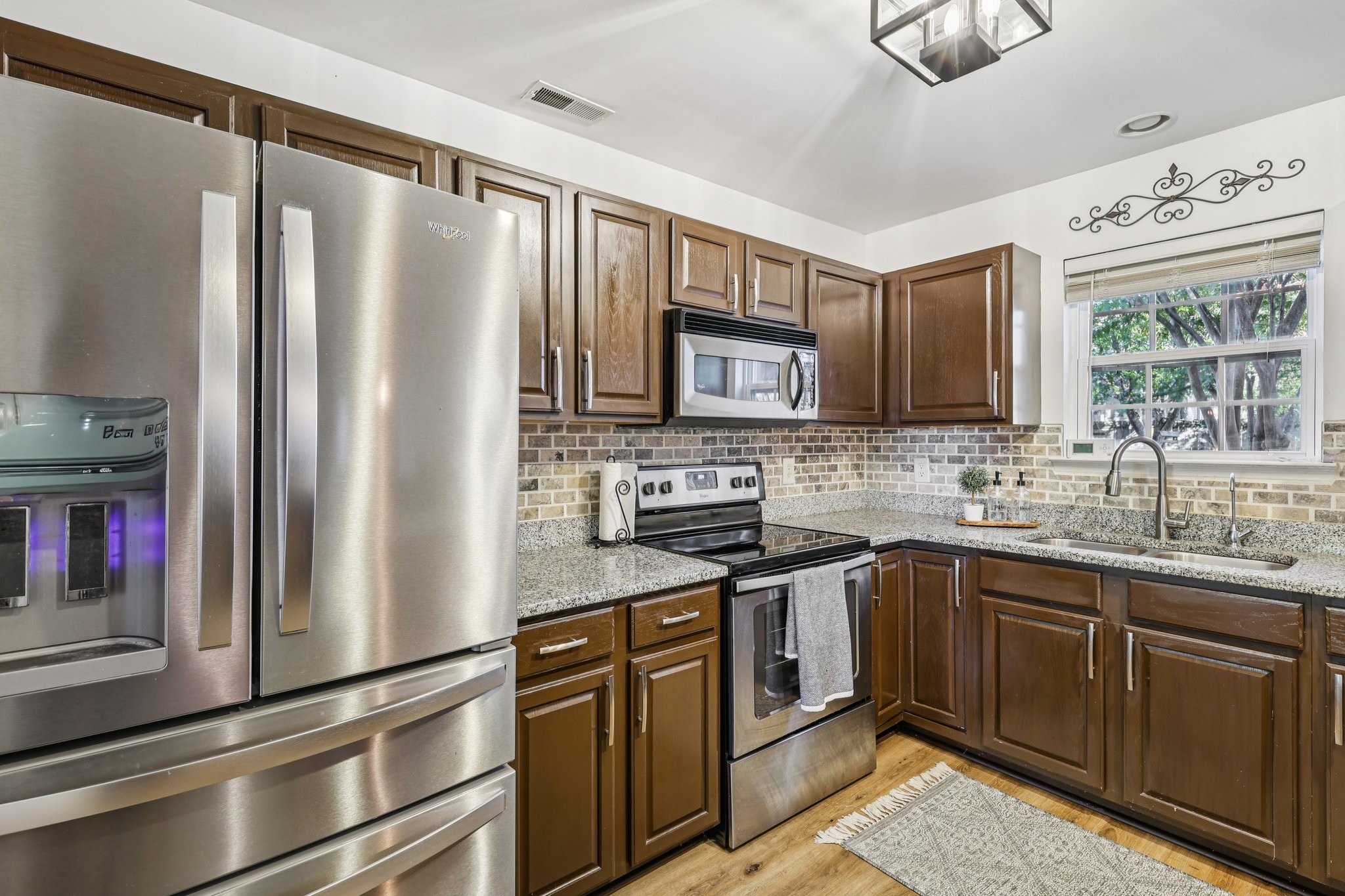 1613 Harrison Way Spring Hill, TN 37174 - Photo 10 of 38 a kitchen with stainless steel appliances granite countertop a refrigerator sink and stove