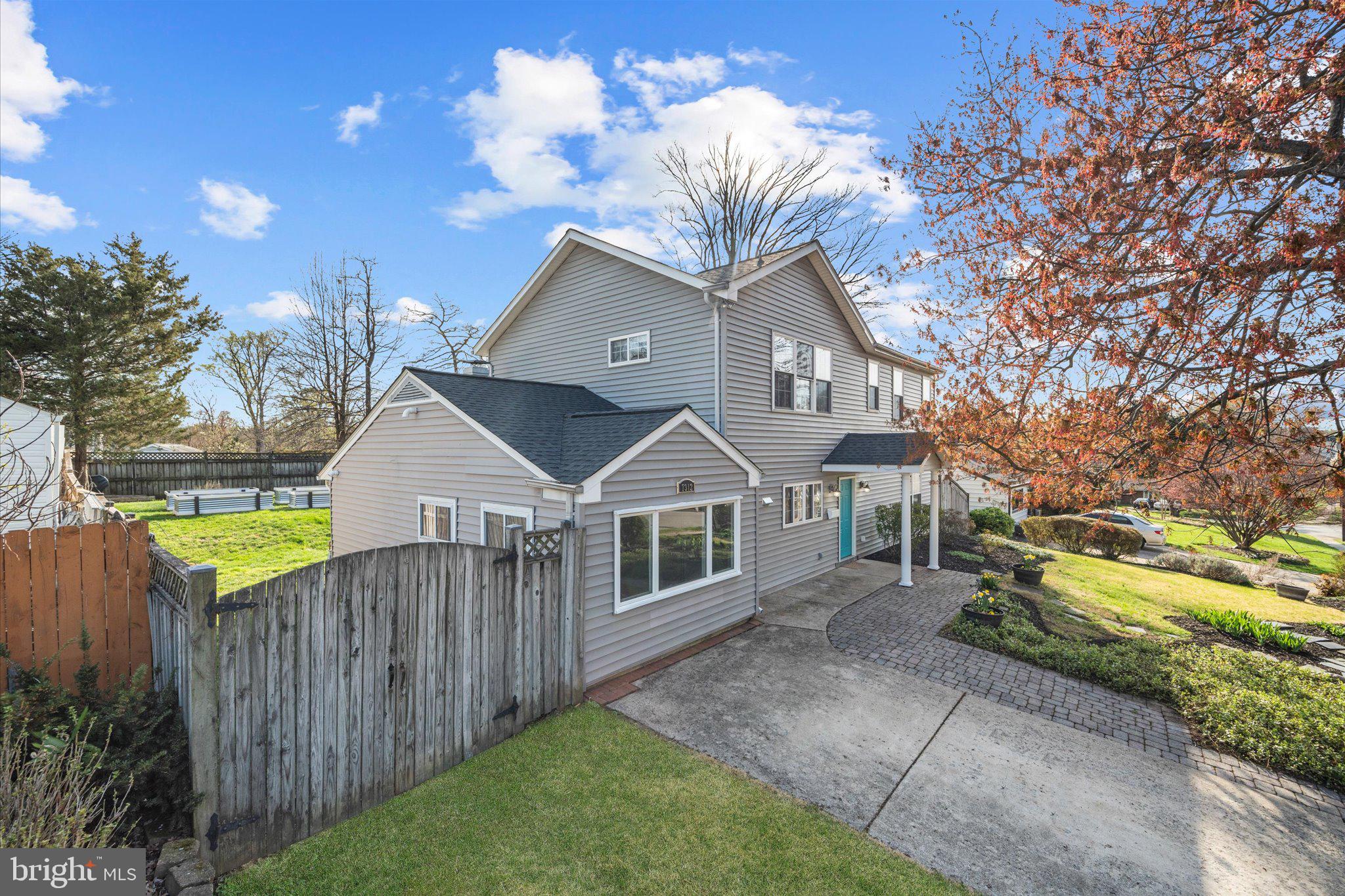 7312 Falmouth Street Springfield, VA 22150 - Photo 2 of 41 a front view of a house with a garden and trees