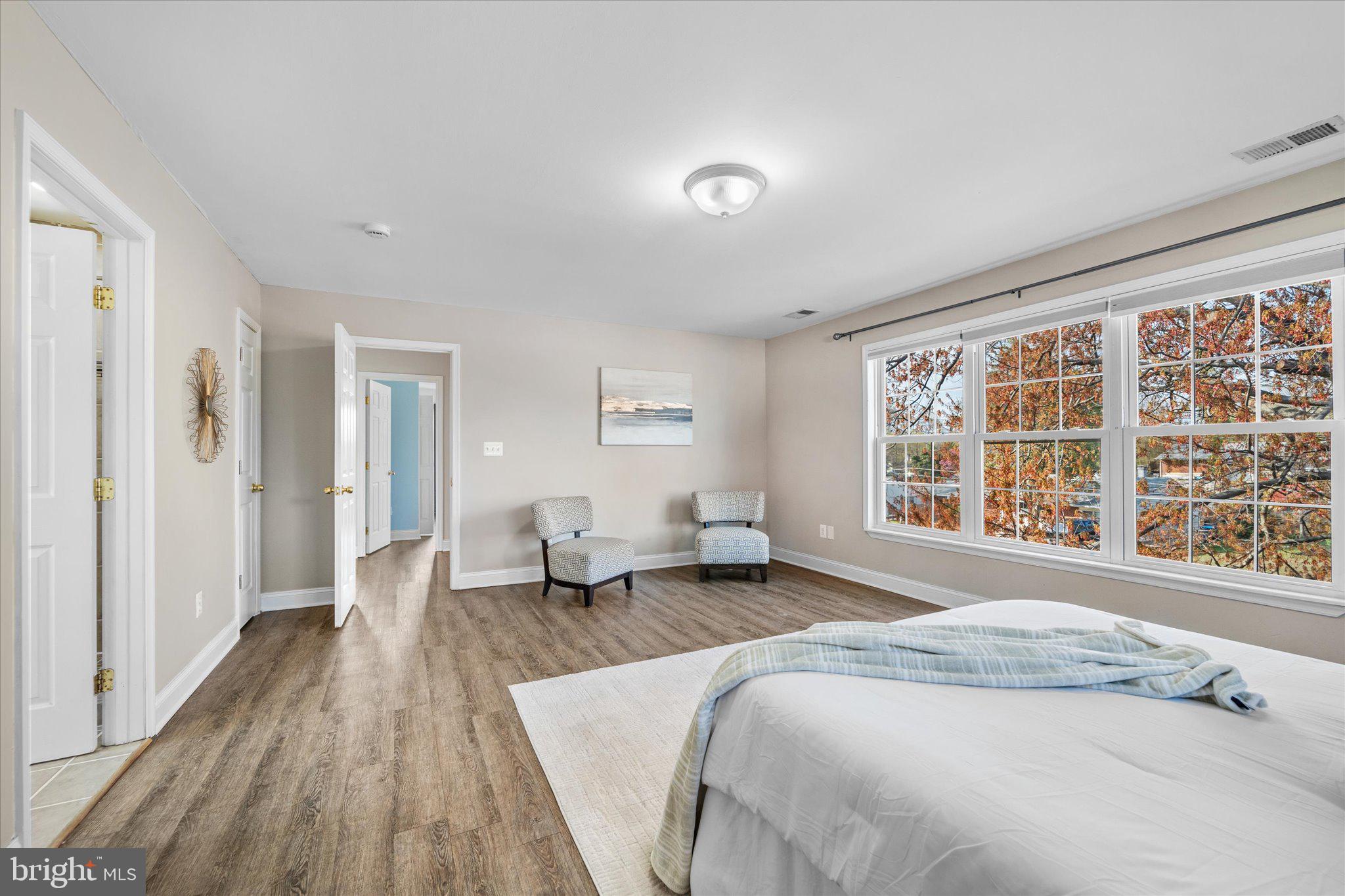 7312 Falmouth Street Springfield, VA 22150 - Photo 23 of 41 a spacious bedroom with a large bed couch and a window