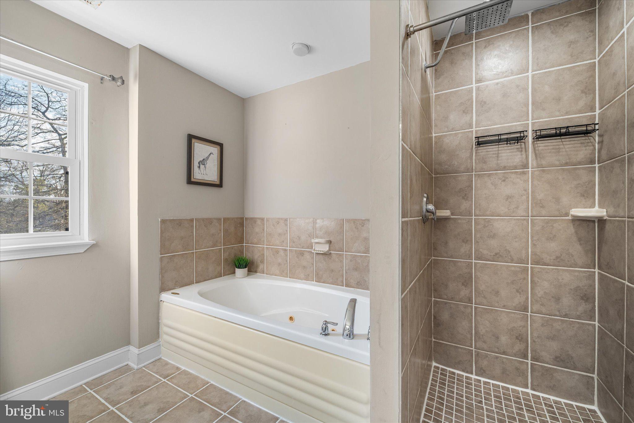 7312 Falmouth Street Springfield, VA 22150 - Photo 26 of 41 a bathroom with a tub shower and a window