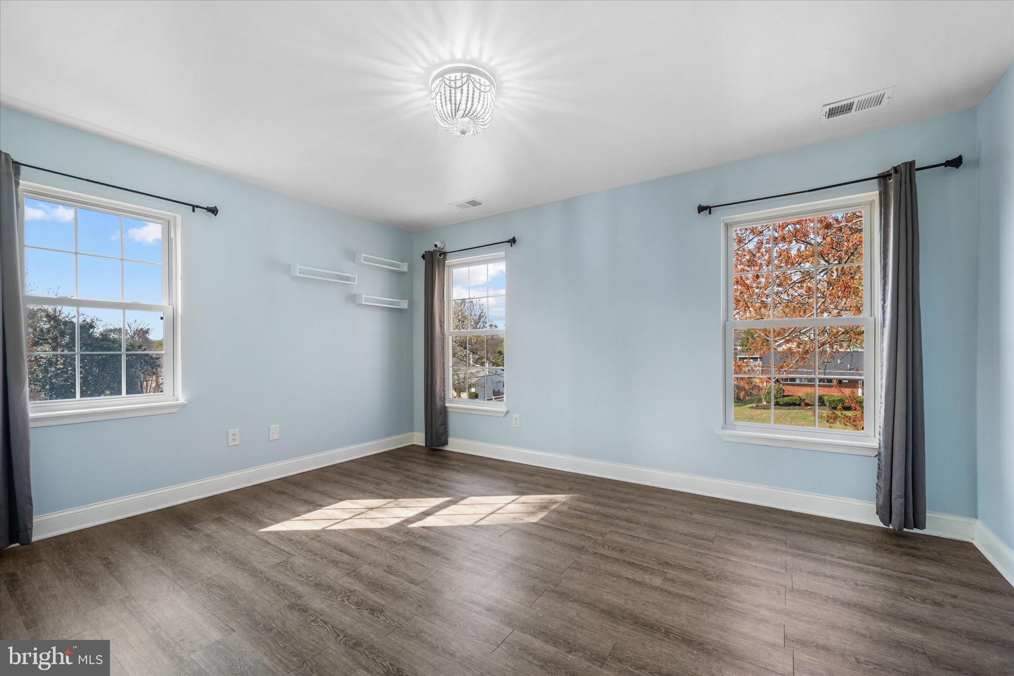 7312 Falmouth Street Springfield, VA 22150 - Photo 27 of 41 a view of an empty room with a window and wooden floor