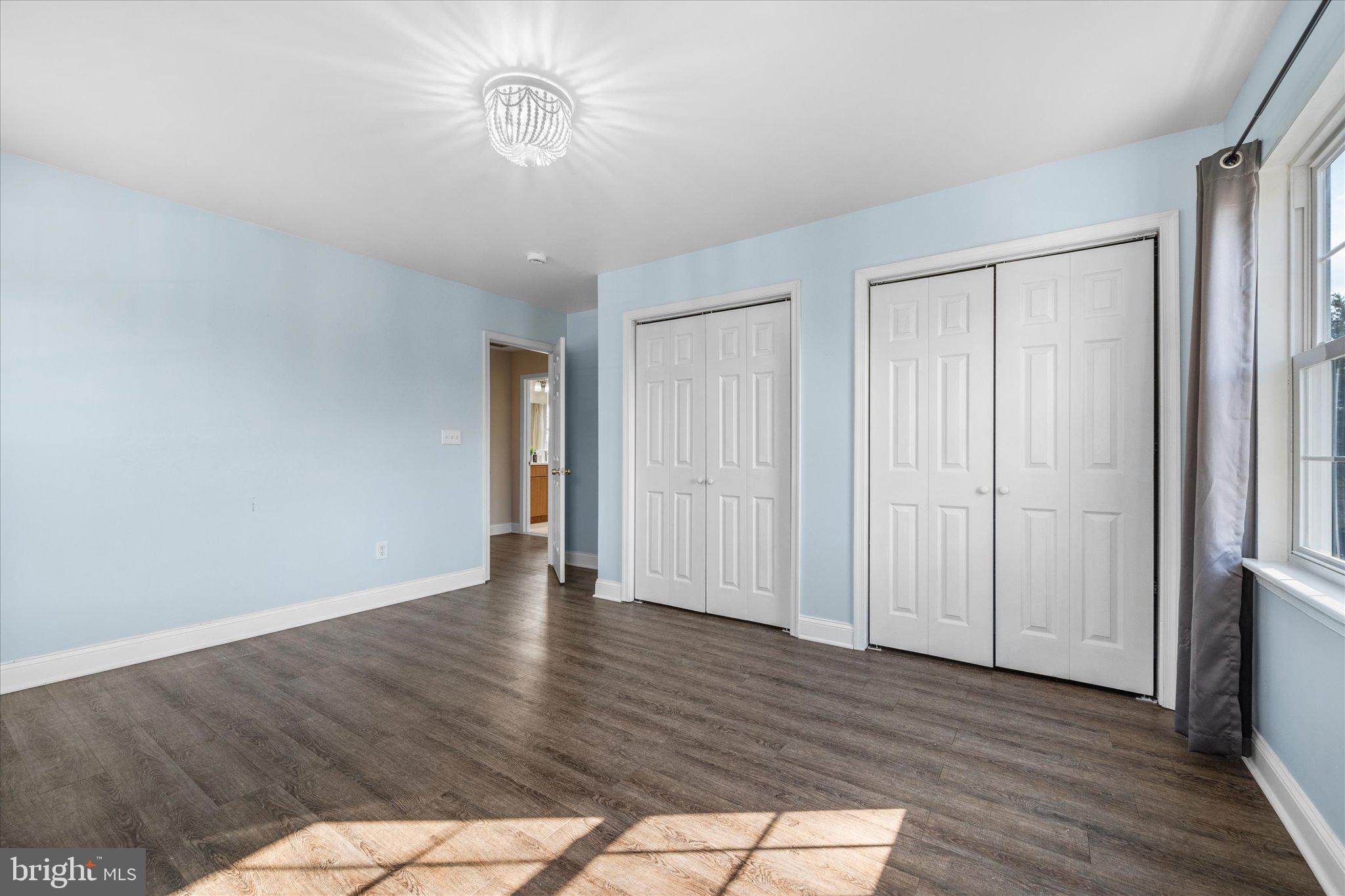 7312 Falmouth Street Springfield, VA 22150 - Photo 28 of 41 a view of an empty room with wooden floor and a window