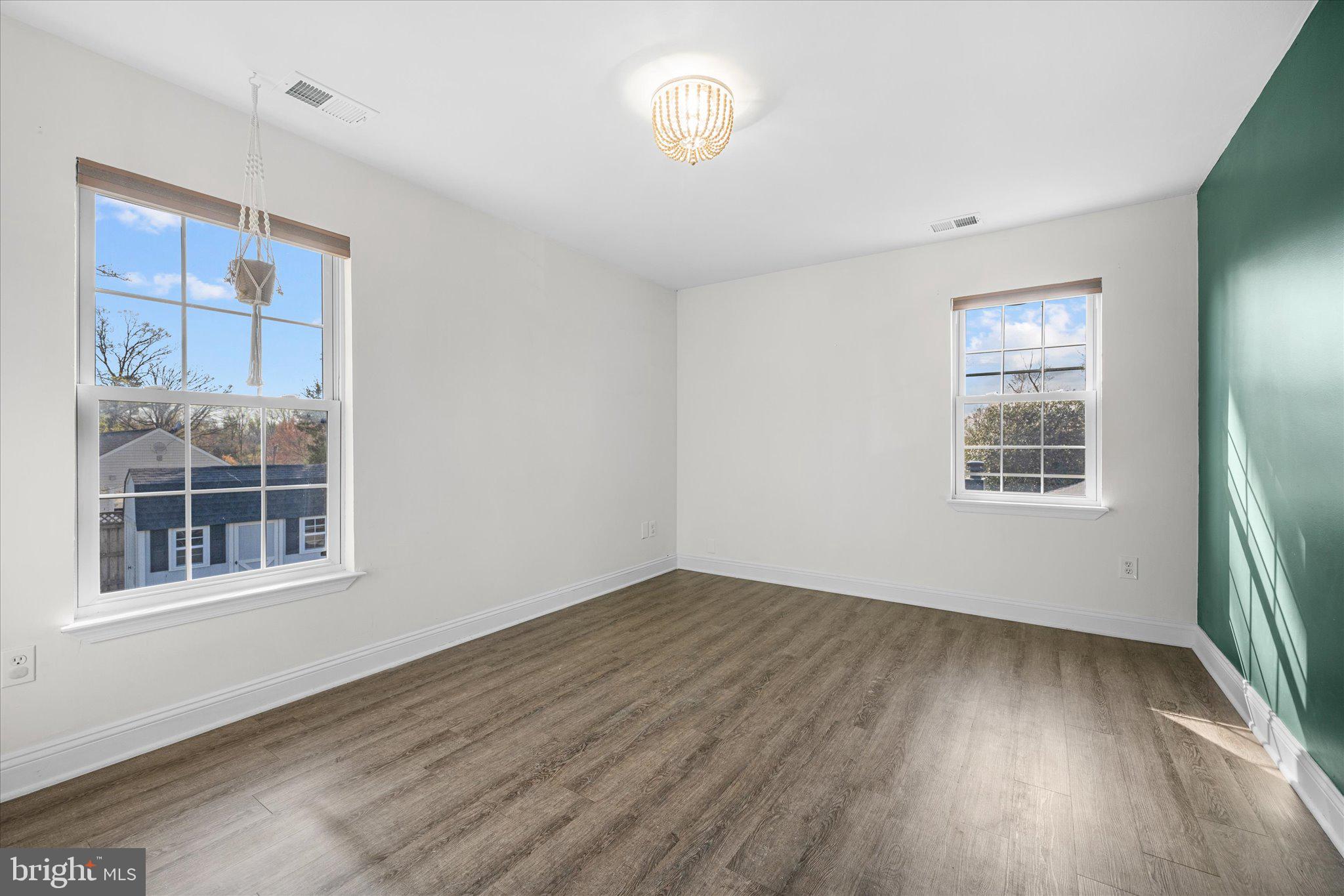 7312 Falmouth Street Springfield, VA 22150 - Photo 29 of 41 a view of an empty room with wooden floor and a window