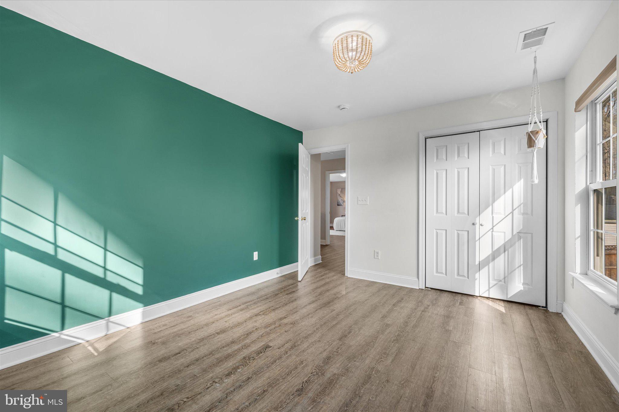 7312 Falmouth Street Springfield, VA 22150 - Photo 30 of 41 a view of empty room with wooden floor and fan