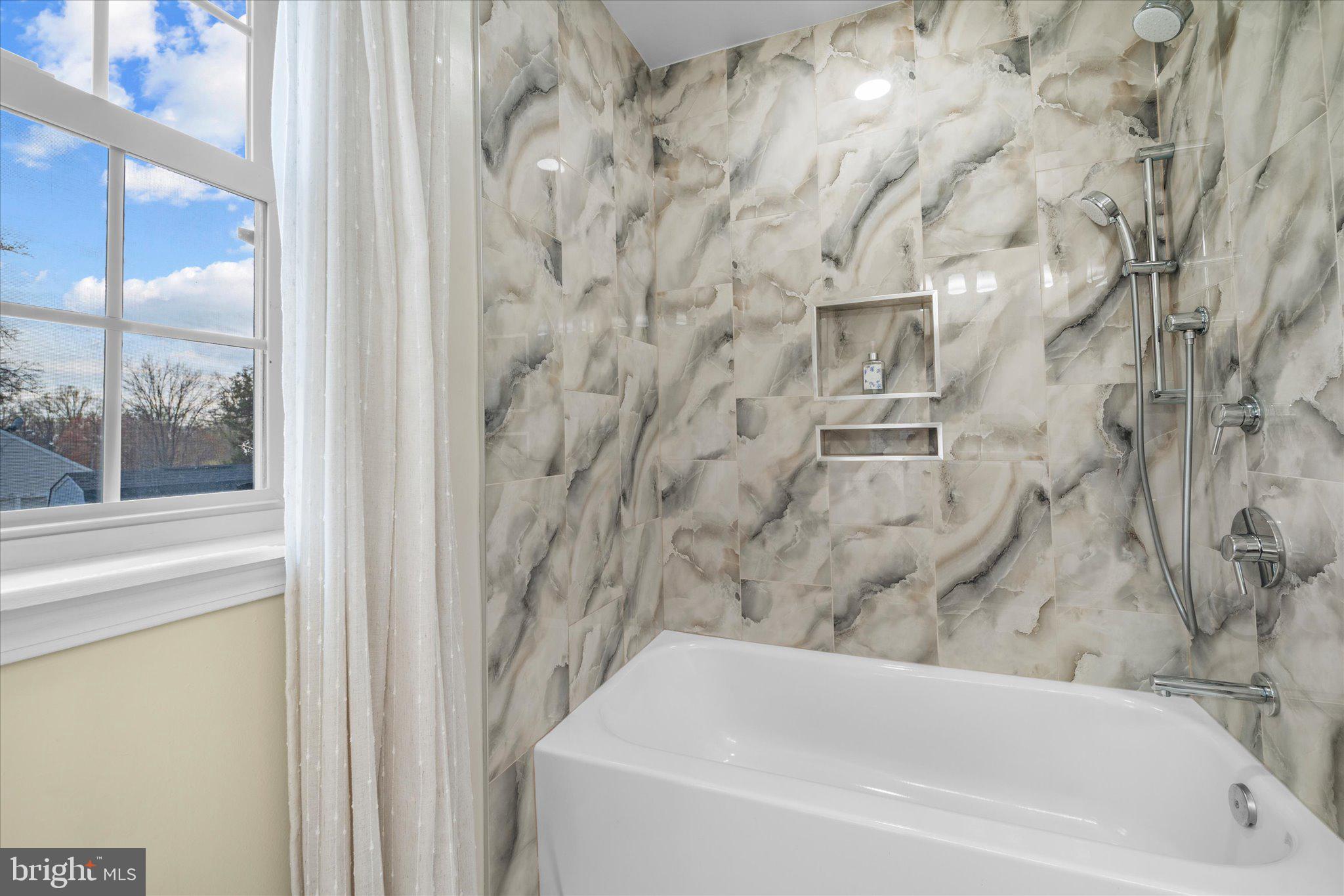 7312 Falmouth Street Springfield, VA 22150 - Photo 32 of 41 a bathroom with a bathtub