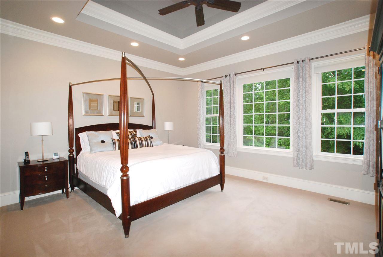 1093 Tacketts Pond Drive Raleigh, NC 27614 - Photo 10 of 25 a bed room with a bed and a large window