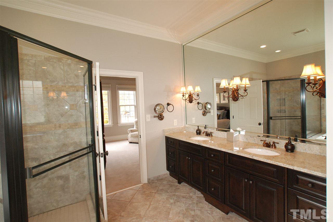 1093 Tacketts Pond Drive Raleigh, NC 27614 - Photo 11 of 25 a bathroom with a double vanity sink mirror and shower